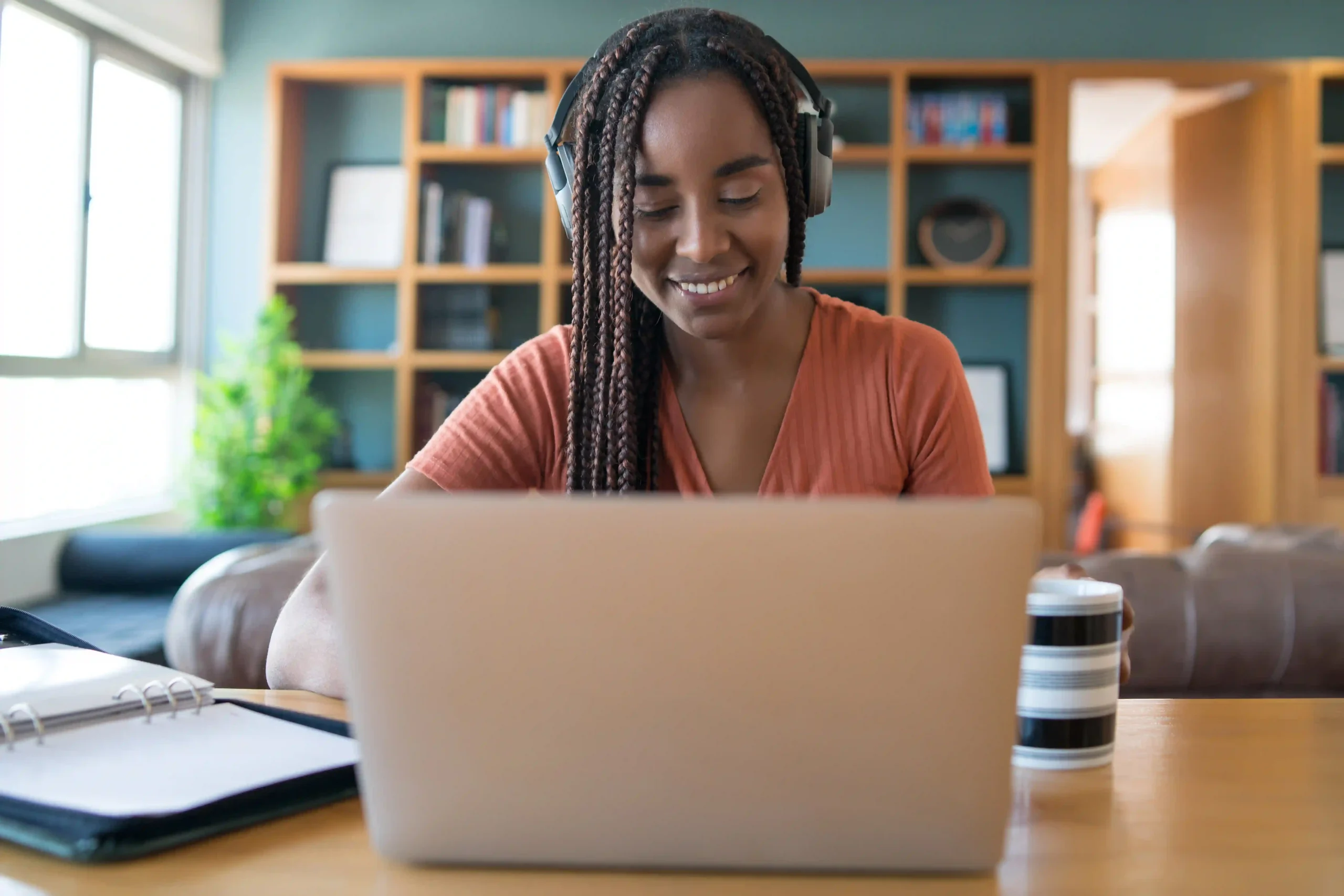 portrait-woman-video-call-with-laptop-headphones-while-working-from-home-concept